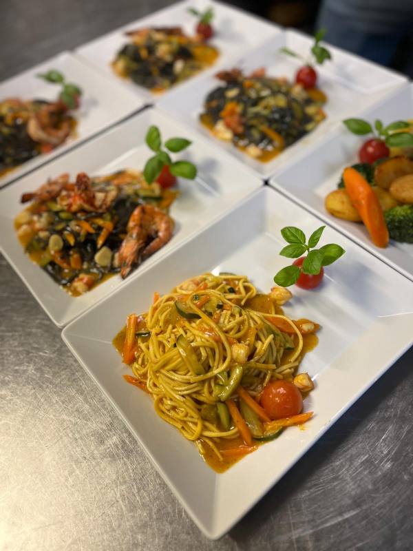 Pasta and antipasti served on platters